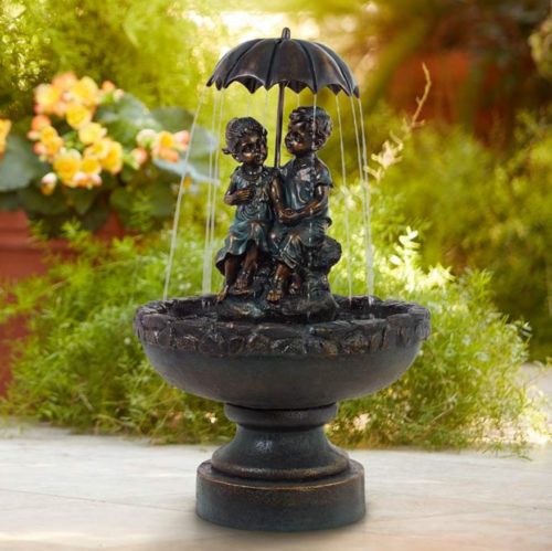boy and girl outdoor umbrella water fountain